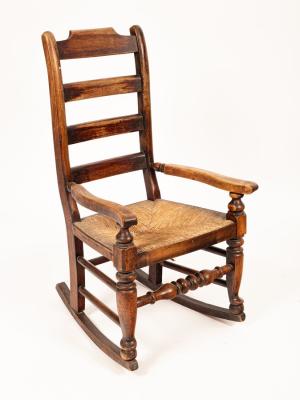 A beech framed ladderback rocking chair,