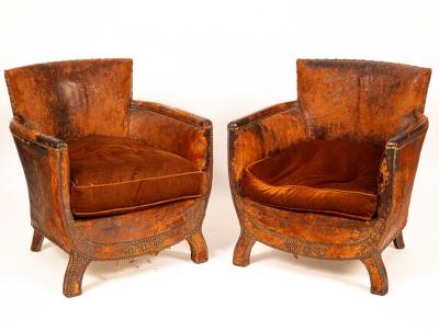 A pair of brown leather tub chairs 36b535