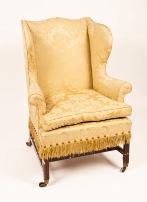 A George III mahogany wing armchair,