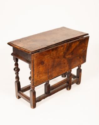 A 17th Century oak gateleg table, on