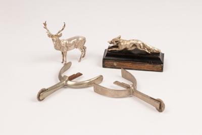 A silver figure of a standing stag,