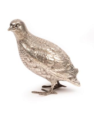 A silver figure of a partridge,
