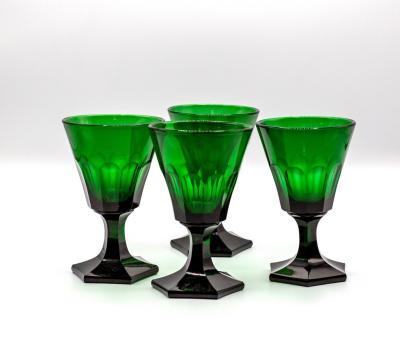 Four early 20th Century green glass