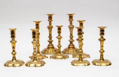 A set of four 18th Century brass candlesticks
