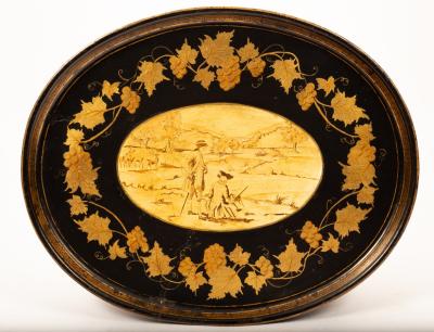 An oval toleware tray with a central