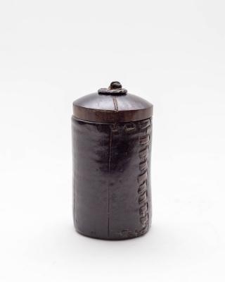 A small leather pot, cylindrical