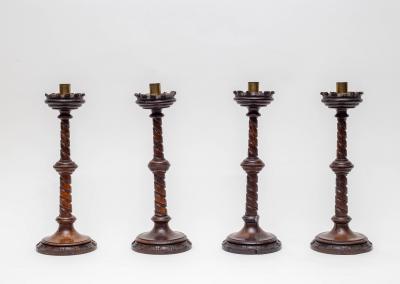 Four wooden candlesticks, in the