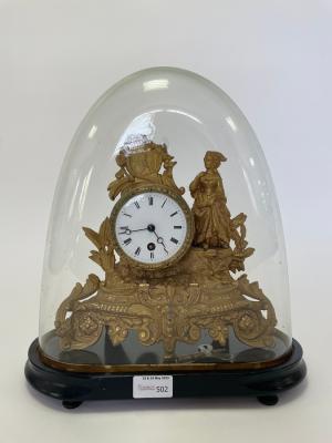 A gilt metal cased mounted clock with