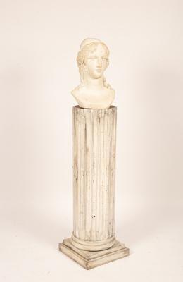 A Classical plaster bust on a fluted