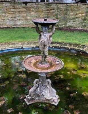 A lead fountain with putto on swan