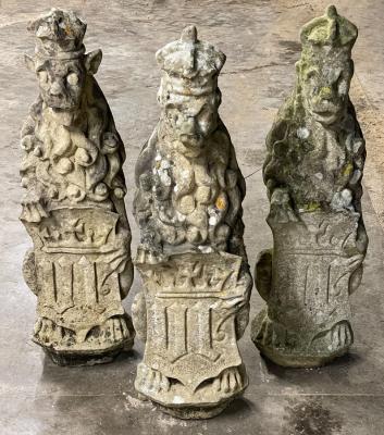 Three carved stone figures of lions,