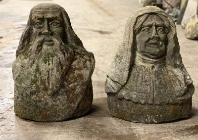 A pair of sandstone busts of a woman