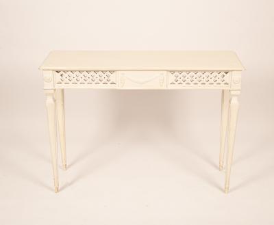 A white painted side table with a pierced
