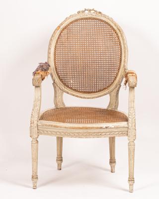 A cane seated open armchair with