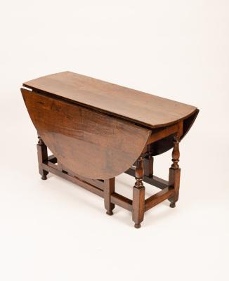 A George I oak gateleg table, the