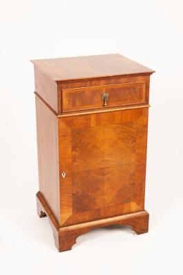 A walnut bedside cupboard with