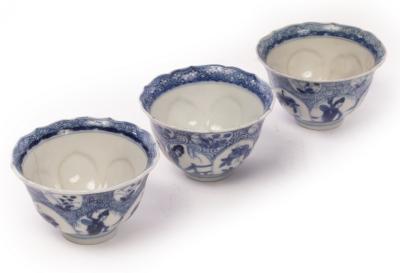 A set of three blue and white tea