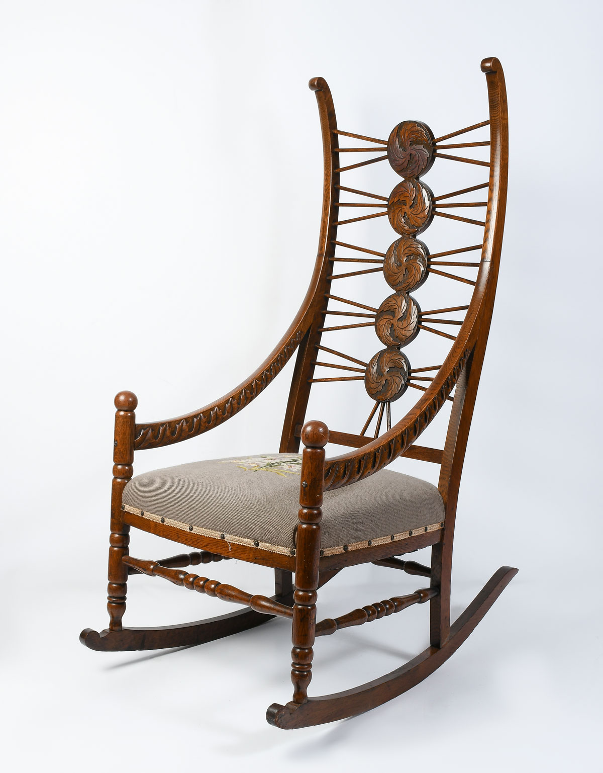 CARVED OAK ROCKING CHAIR WITH NEEDLEPOINT: