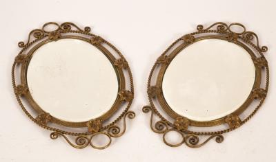 A pair of brass oval mirrors the 36c133