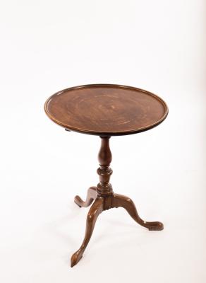 A mahogany tripod table with a dished