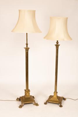 Two brass standard lamps, the largest