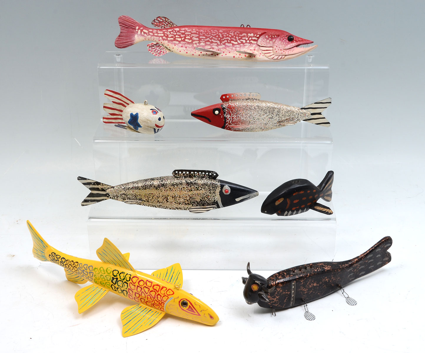 SEVEN HAND-CARVED AND PAINTED FISH