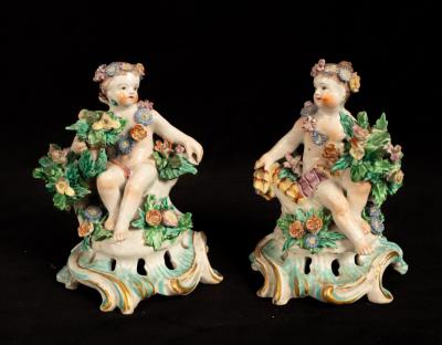 A pair of Bow porcelain seated cherub