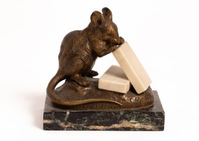 A bronze figure of a mouse eating 36c5f1