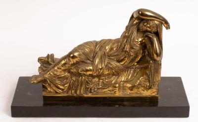 A gilt metal figure of a reclining 36c606