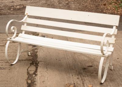 A garden bench with slatted wooden seat,