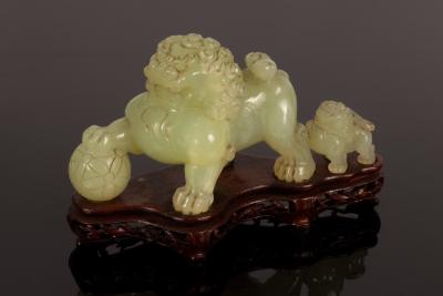 A celadon jade caving of a foo dog and