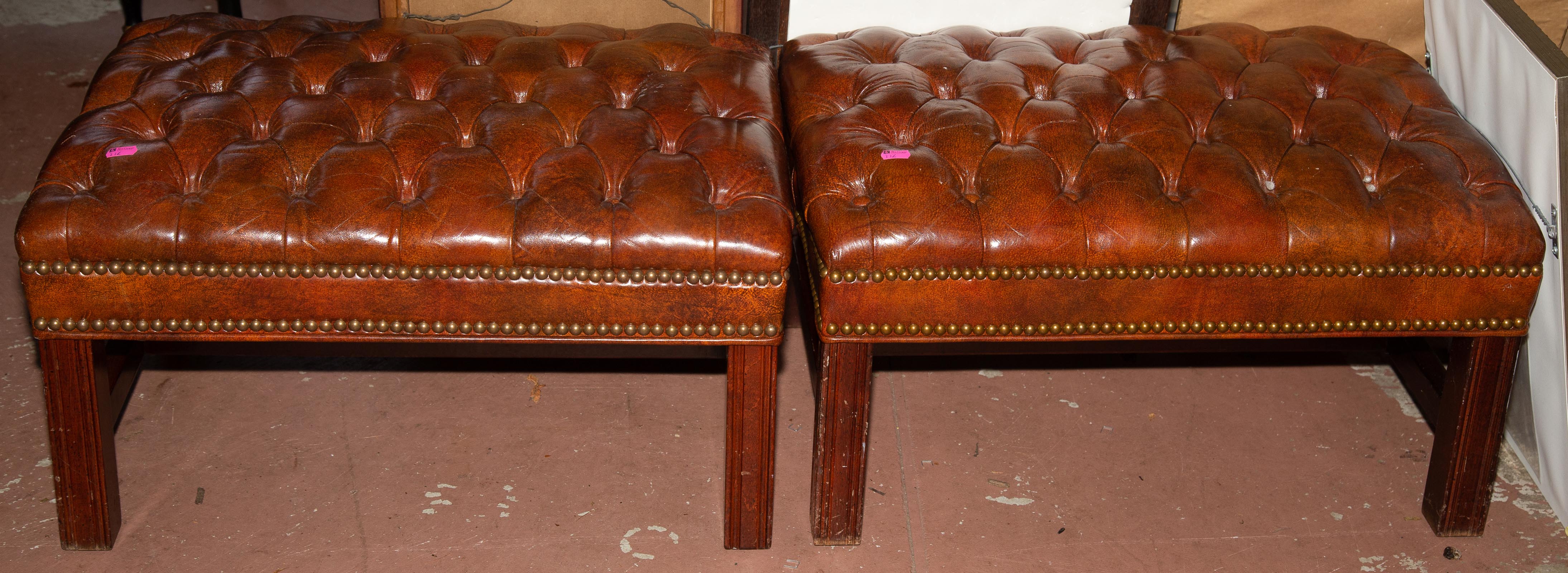 TWO FAUX LEATHER OTTOMANS *located