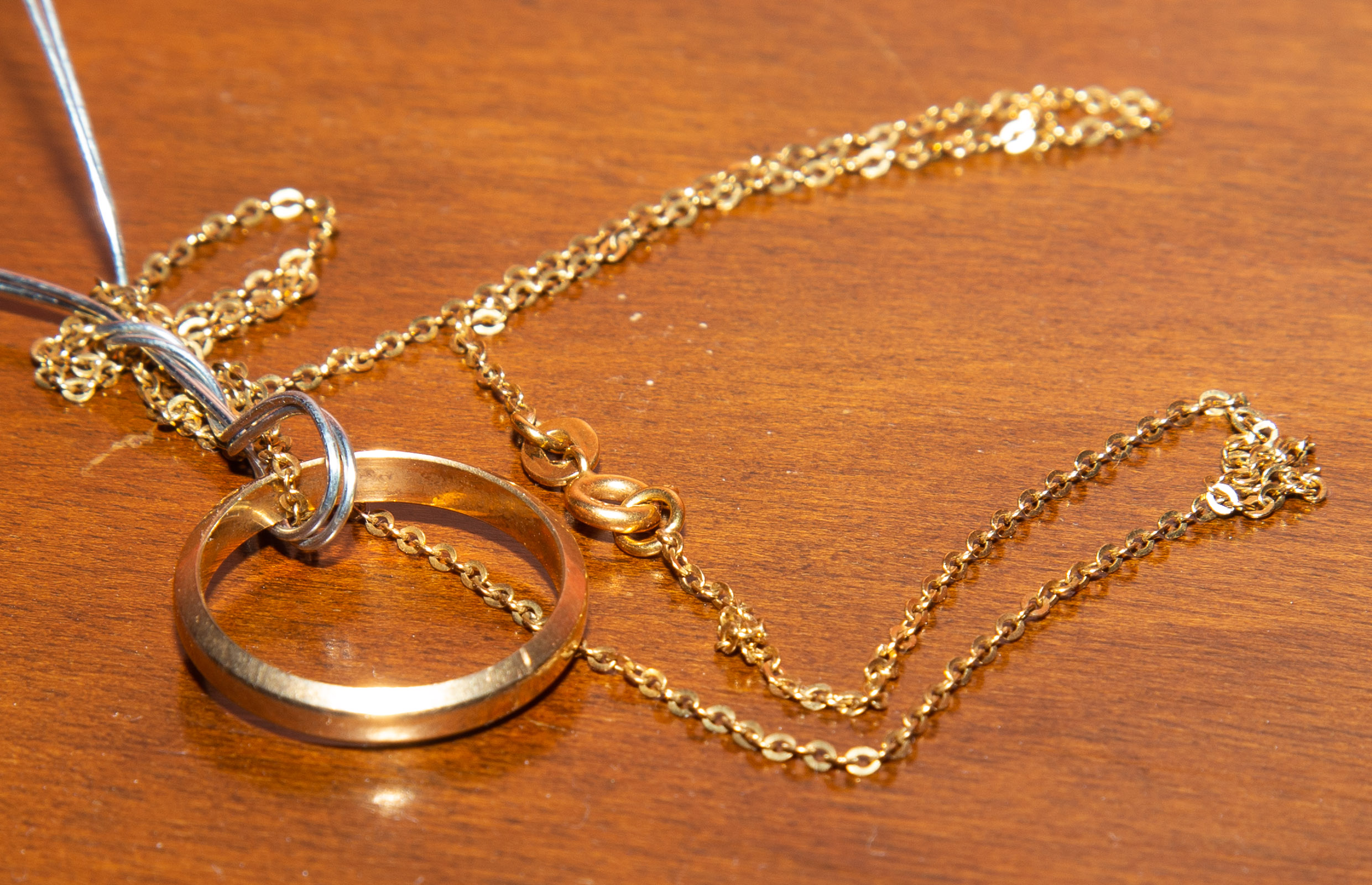 A 14K WEDDING BAND ON 18K CHAIN