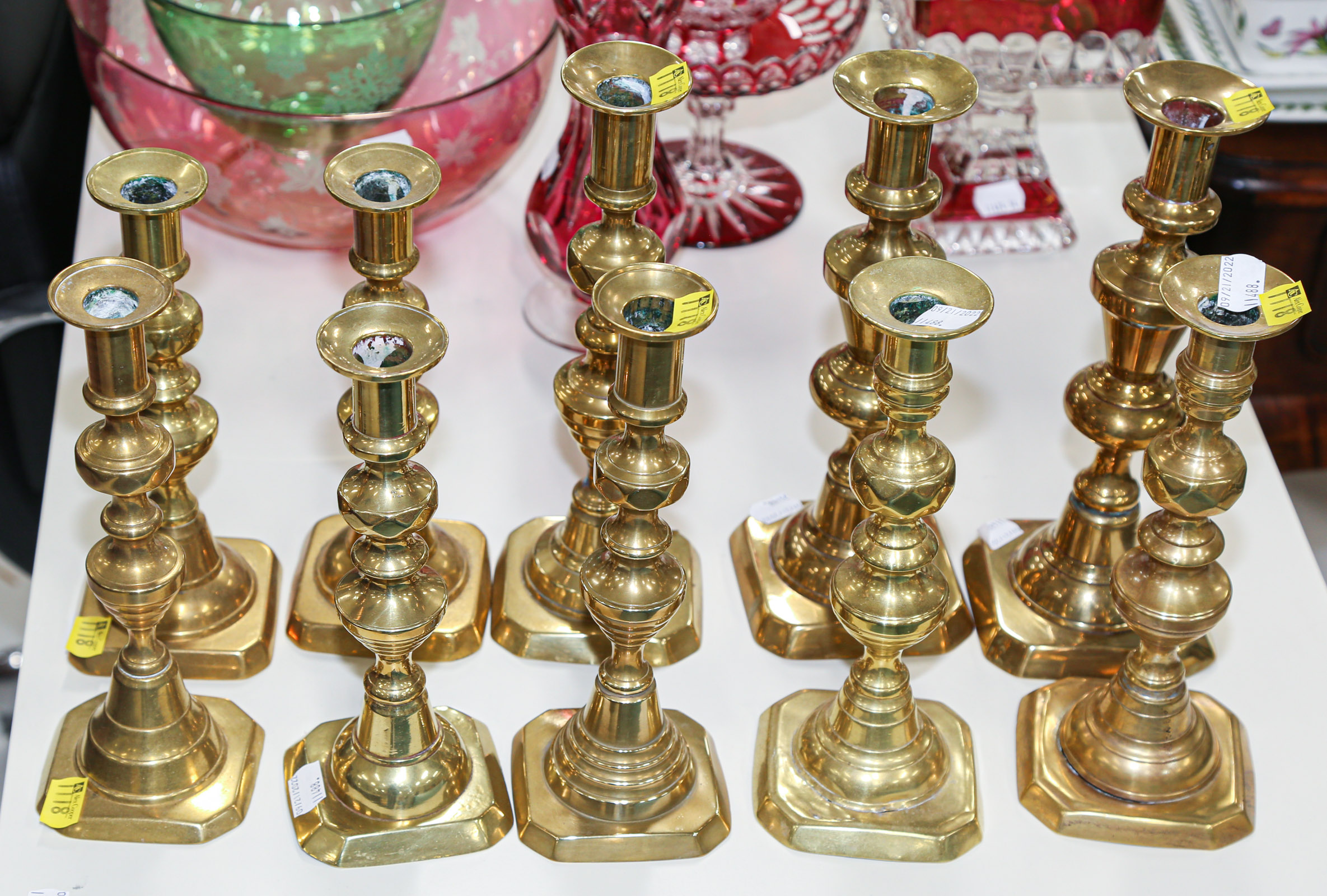 FOUR PAIRS OF ANTIQUE BRASS CANDLESTICKS