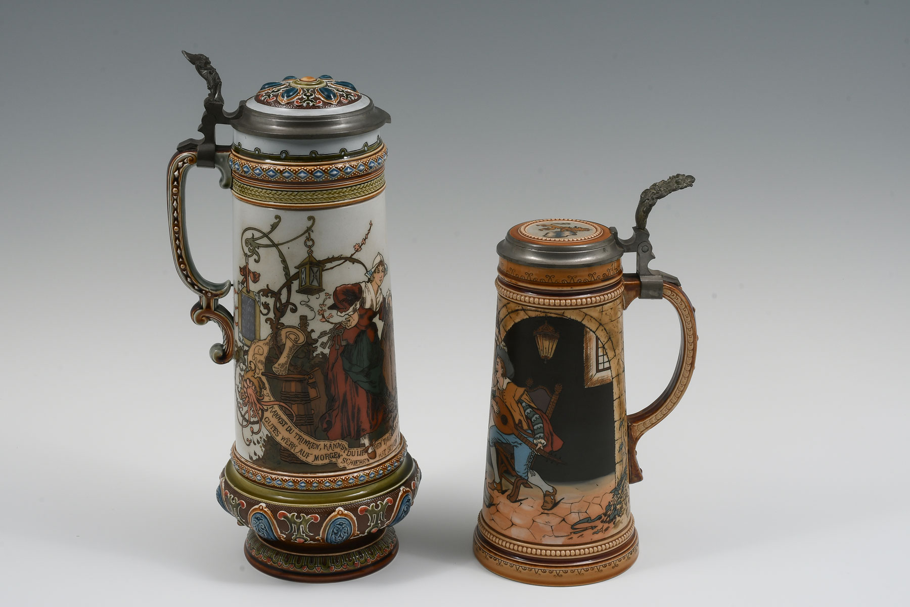 2 PC. METTLACH FIGURAL STEINS: