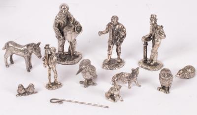 A group of white metal figures, including