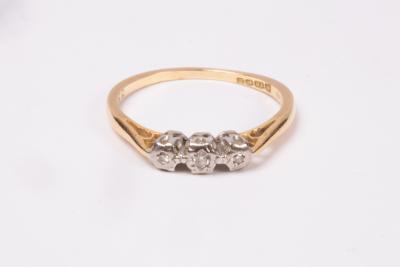 A diamond three-stone ring, illusion