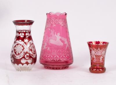 A cranberry glass vase etched scenes