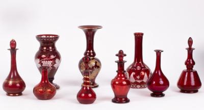 A quantity of ruby glass vases