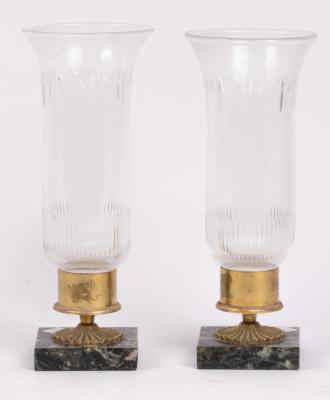 A pair of glass and marble candleholders,