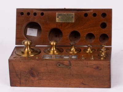 A mahogany case of thirteen brass
