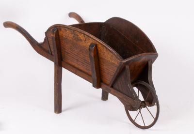 A Victorian oak wheelbarrow with