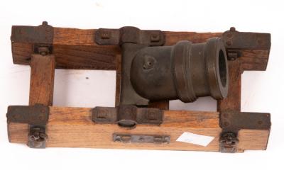 A small squat cannon on a metal mounted