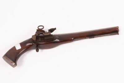 A flintlock pistol with embossed floral