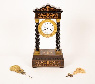A French ebonised portico clock,