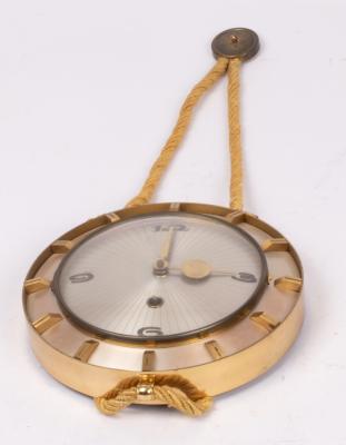 A 1960s clockwork wall clock in a brass