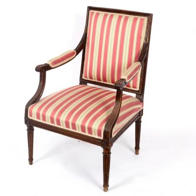 An upholstered open armchair, the reeded