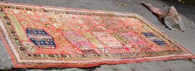 A Khotan rug decorated vases of
