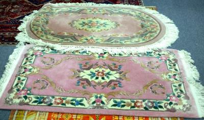 A Chinese pink ground rug, 157cm