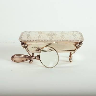 A silver dressing table box with hinged